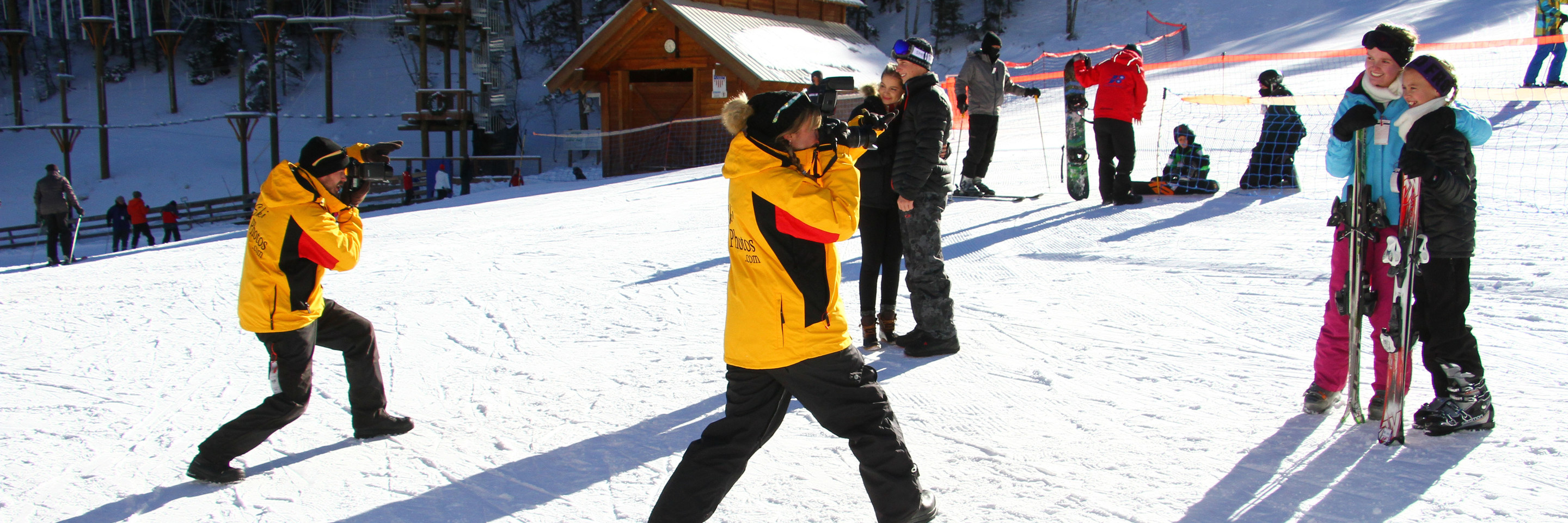 photographers taking photos of people skiing