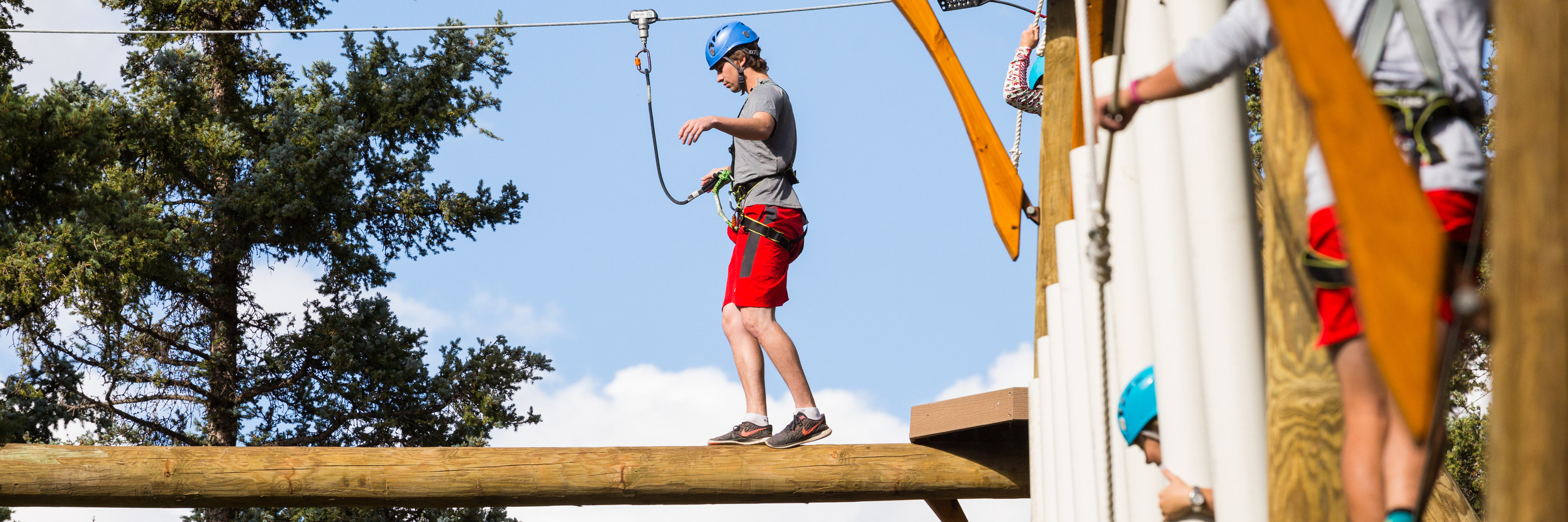 Man balancing on  Aerial Park element - summer vacation getaways in New Mexico